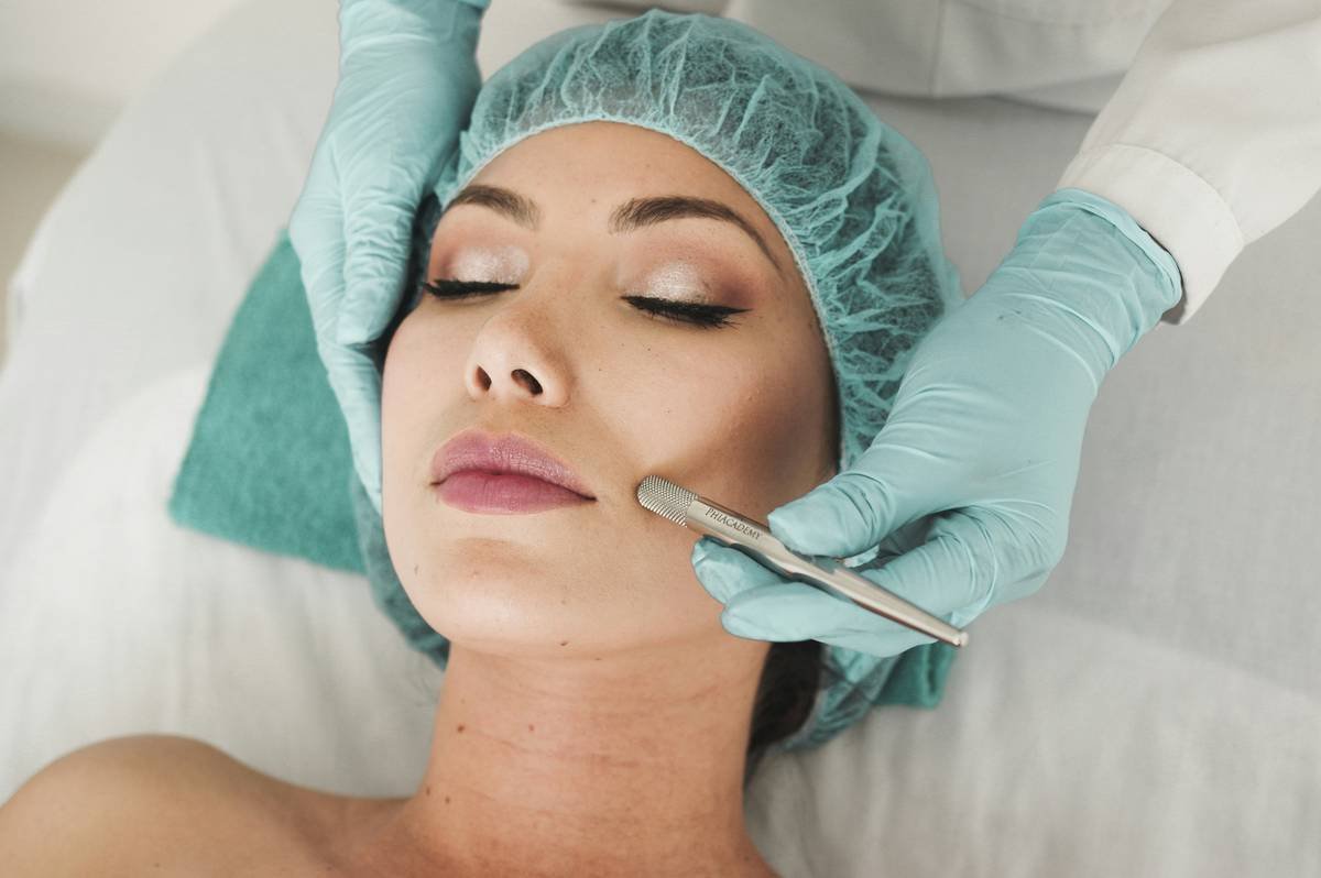 Woman applying toner for oily skin with clean hands on a matte-finish cotton pad alternative